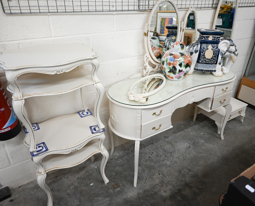 A cream paint finished Italian-style mirror-backed kidney shaped dressing table by Fairyland to/w