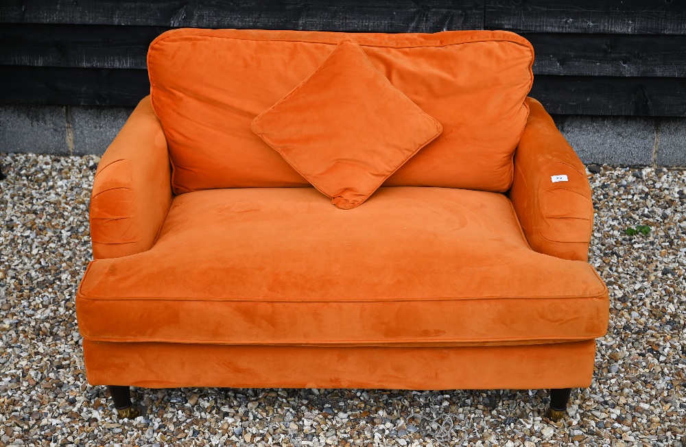 A contemporary plush burnt orange upholstered 'love chair', raised on turned front legs to brass - Image 2 of 2