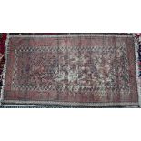 A worn Persian red and brown Balouch rug, 178 x 100 cm