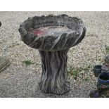 A naturalistic weathered reconstituted stone birdbath, 64 cm dia. x 70 cm h - note cracks