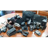 A quantity of cameras including Nikon D3200 digital SLR camera, SLR lenses, vintage cameras, etc all