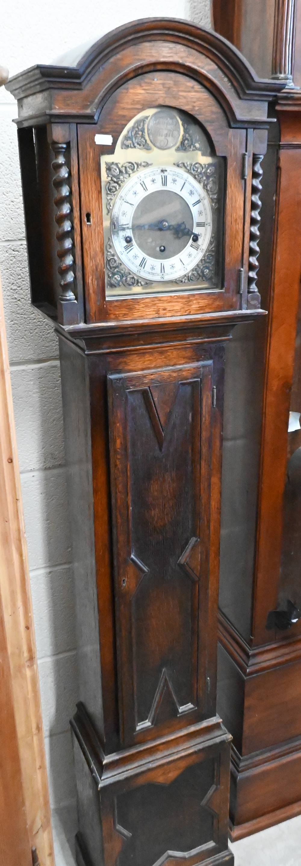 An oak shortcase clock with geometric panelled case, brass dial and triple train movement,