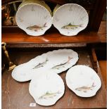A set of six Limoges shell-dishes printed with fish, to/w a matching long serving dish