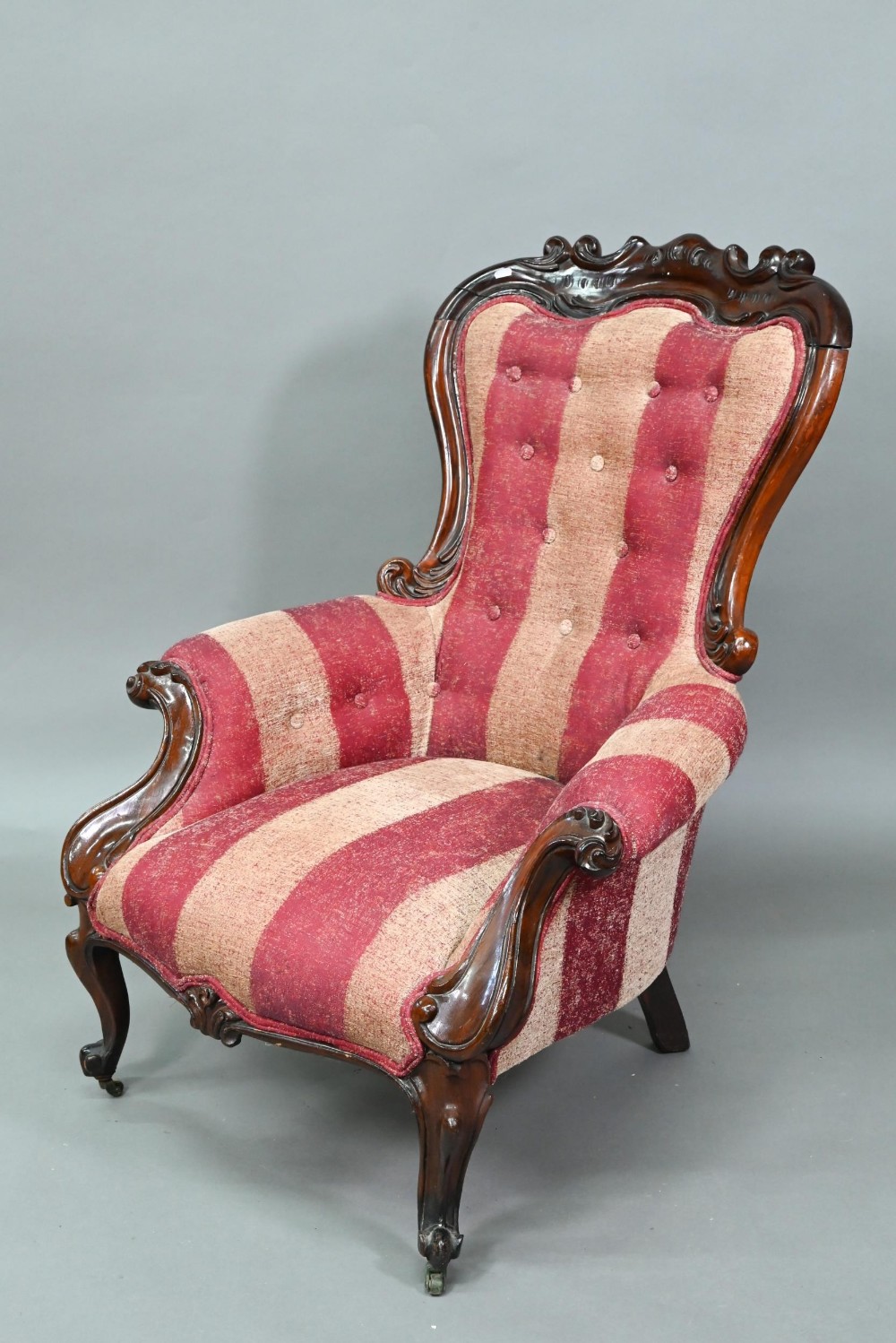 A late Victorian rosewood show framed salon chair, with later button upholstered covers, the front