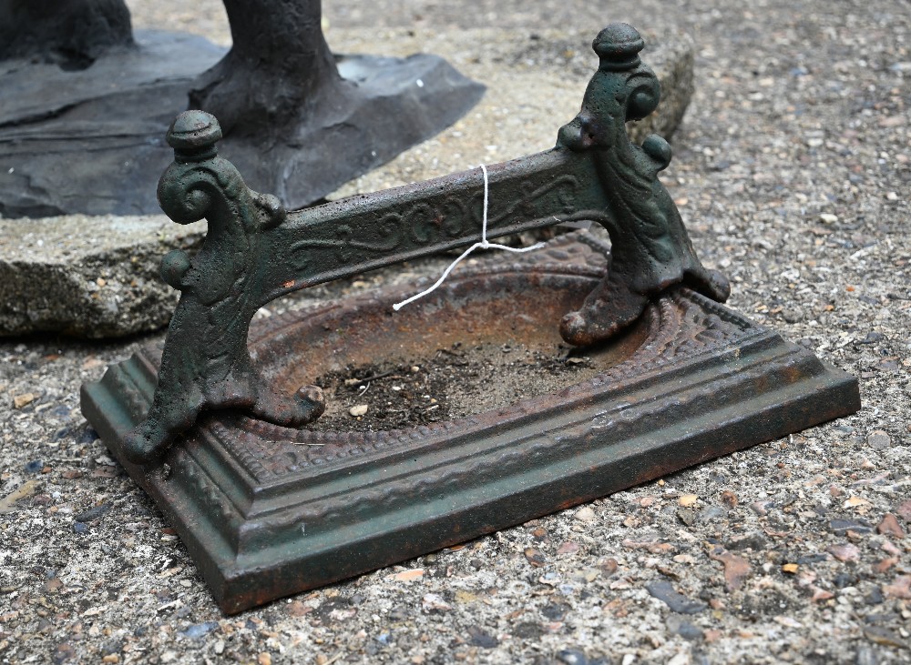 A vintage cast iron boot scraper