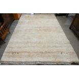 A thick pile Gabbeh wool rug with small animal corner motifs on beige ground, 290 cm x 195 cm