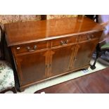 A reproduction yew three drawer over three cupboard sideboard, 122 cm x 45 cm x 81 cm h
