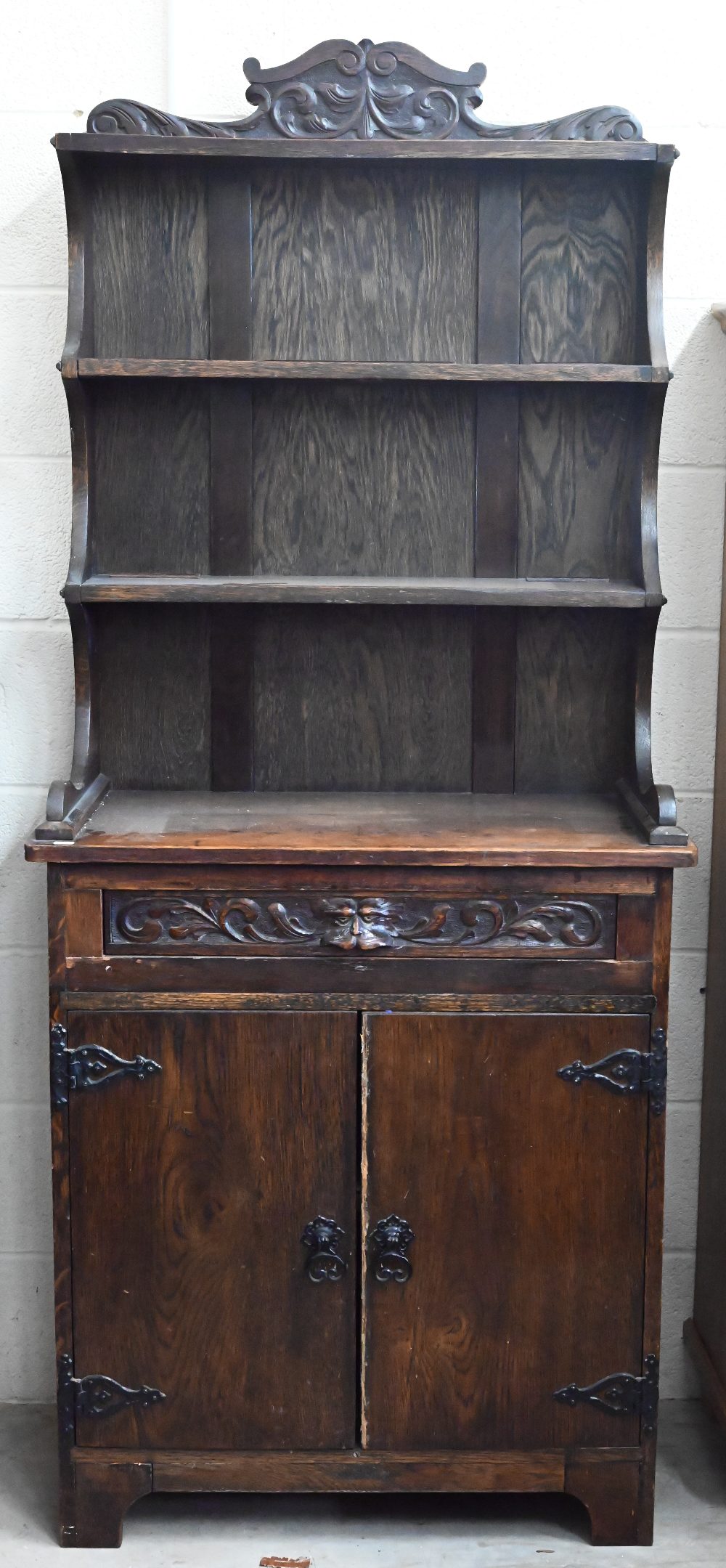 A small carved oak dresser, 80 cm wide x 40 cm deep x 190 cm high