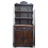 A small carved oak dresser, 80 cm wide x 40 cm deep x 190 cm high