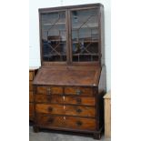 A Georgian mahogany bureau with two short over three long drawers, with associated glazed bookcase