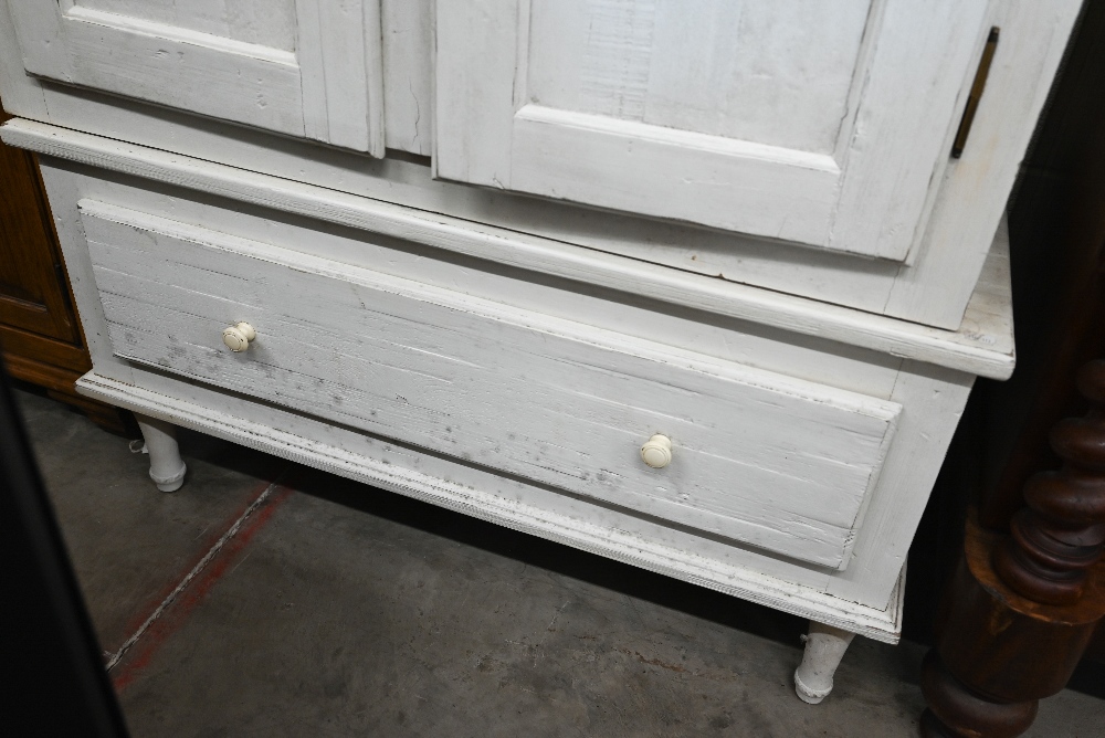 A cream painted pine armoire wardrobe with panelled doors and single drawer (in two sections), by - Image 2 of 3