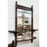 A bevelled wall mirror in fret-cut simulated bamboo frame with three shelves in Chippendale
