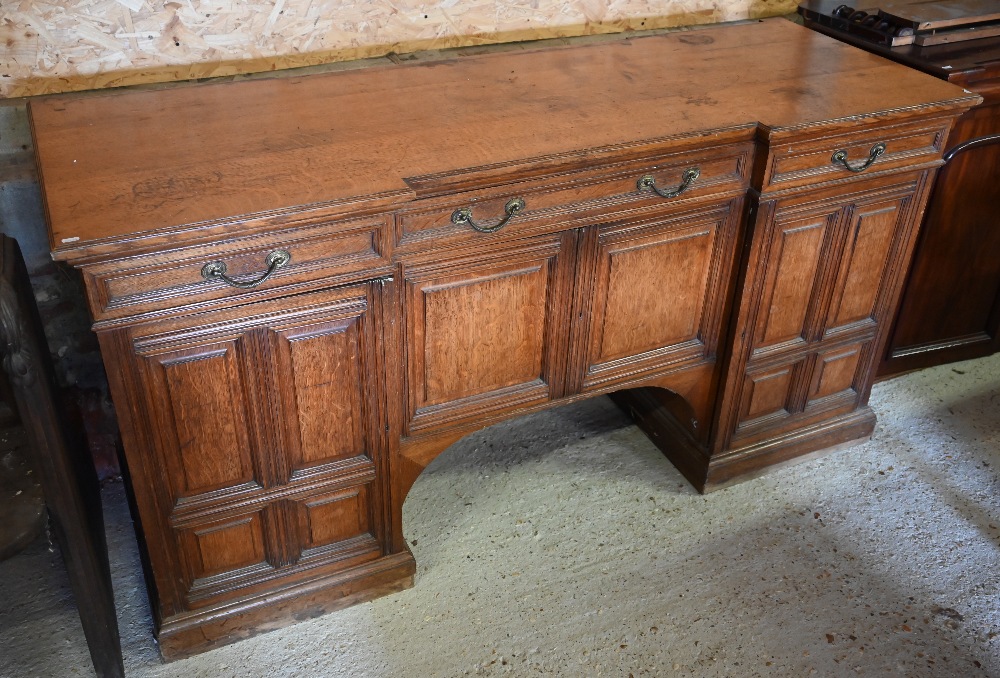 Howard & Sons, Berners St, London, a late 19th century golden oak inverted breakfront sideboard (