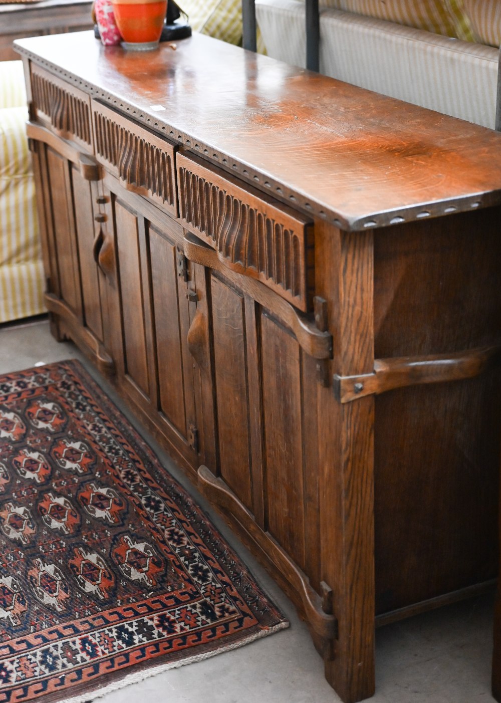 A Continental oak sideboard with three drawers over panelled cupboards, 172 cm wide x 42 cm x 80
