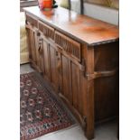 A Continental oak sideboard with three drawers over panelled cupboards, 172 cm wide x 42 cm x 80
