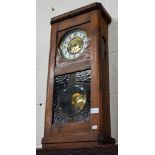 A fruitwood and stained glass twin-train wall clock