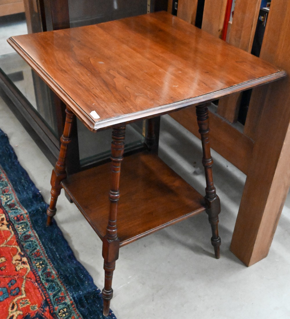 An Edwardian walnut two tier square occasional table in the Liberty manner, 50 cm wide x 50 cm