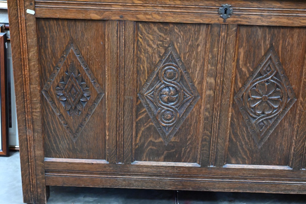 A traditional oak coffer with carved lozenge decoration, on stile feet, 133 x 55 x 76 cm high - Image 2 of 3