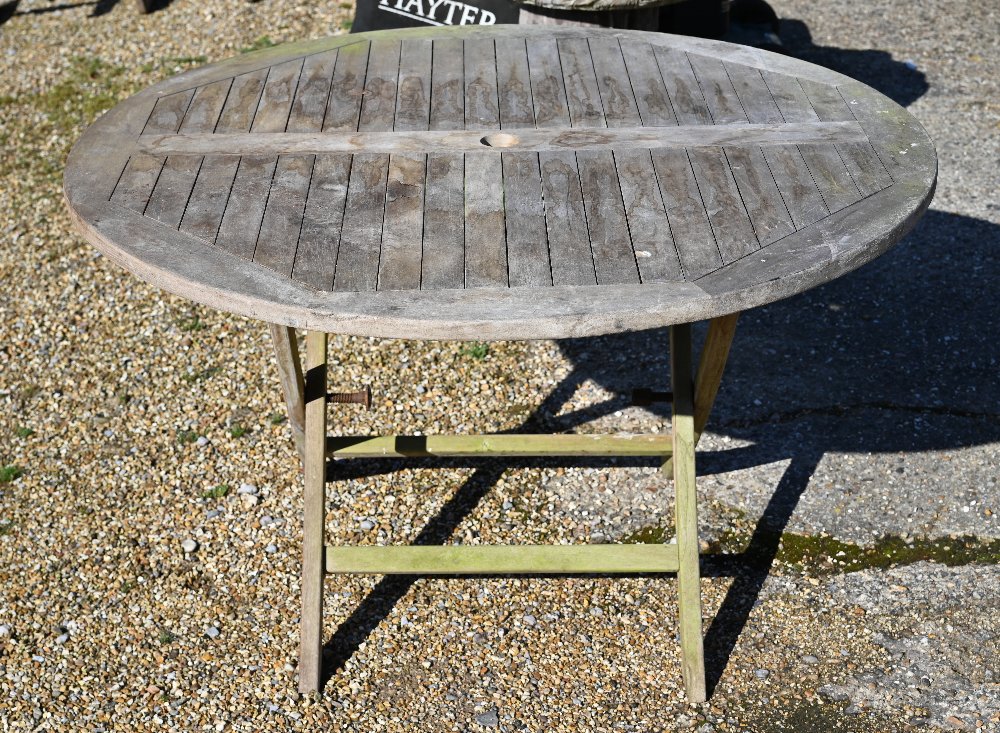 A weathered teak circular garden dining table on folding frame, 120 cm diam x 72 cm high - Image 2 of 2