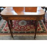 A 19th century mahogany and ebony strung card table with folding baize lined top on turned and