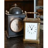 A French brass carriage clock, 15 cm high overall, to/w an American painted tin alarm clock (2)