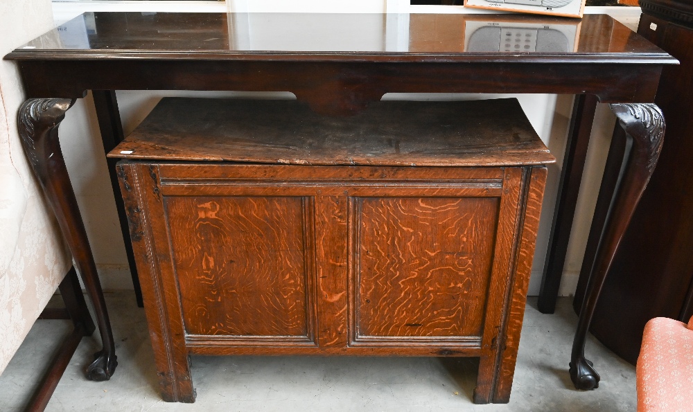 A Georgian style mahogany console table on acanthus carved cabriole supports with ball and claw