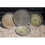 Four large Eastern copper circular trays with engraved decoration