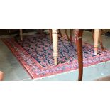 A Persian Senneh rug, the repeating boteh design on blue ground with red borders, 200 x 130 cm