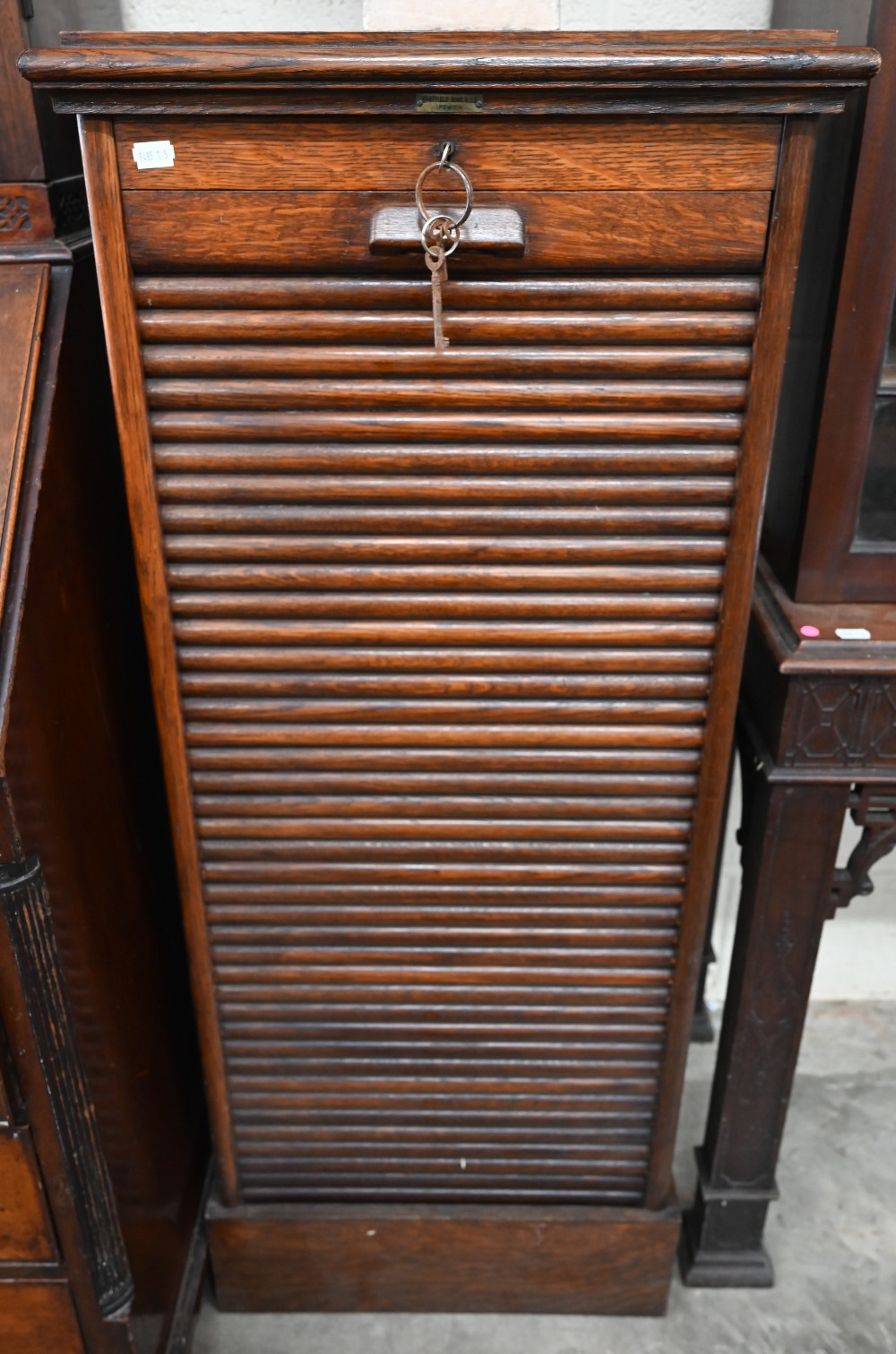 An early 20th century oak tambour front filing chest 'Whitfield King & Co, Ipswich' plaque, c/w key,