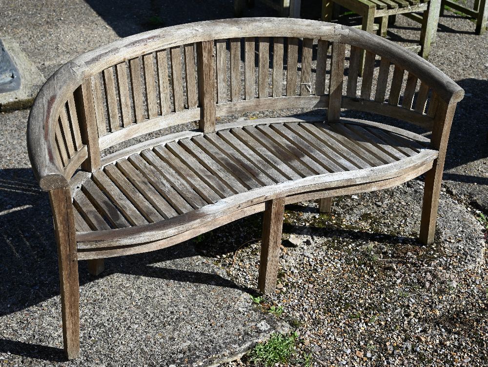 A Tansley curved slatted teak garden bench, 160 cm wide