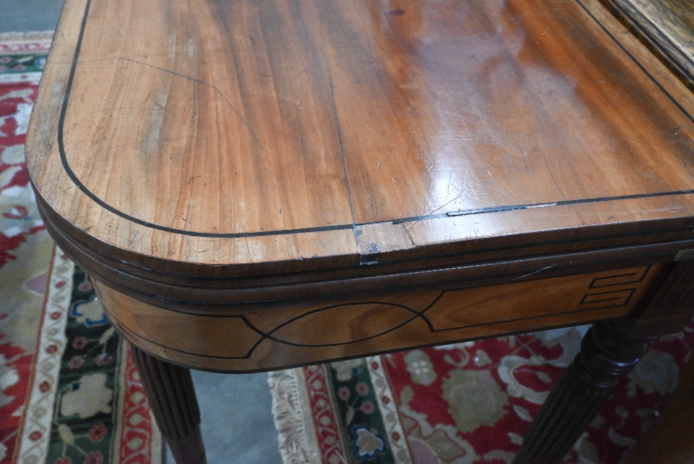 A 19th century mahogany and ebony strung card table with folding baize lined top on turned and - Image 4 of 4