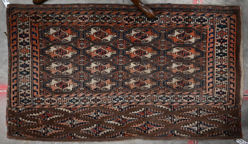 A vintage Turkoman brown and red geometric gul design bag-face, 125 cm x 73 cm