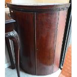 A 19th century mahogany barrel front hanging corner cupboard