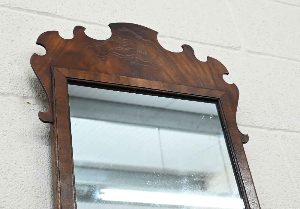 A Georgian-style wall mirror in fret cut figured hardwood frame, 71 cm high x 36 cm - Image 2 of 2