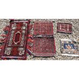 A Persian Turkoman saddle bag, Turkoman carpet bag, large Balouch carpet bag and a Turkish small