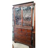 A Georgian mahogany bookcase on chest, the astragal glazed doors over two short and three long