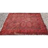 An Afghan gul design rug on red ground, 284 x 157 cm