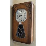 A German Art Deco oak wall clock with octagonal silvered dial, striking and chiming on gongs, 64 cm