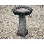 A weathered reconstituted cast stone garden birdbath, the octagonal top on tapering base, 41 cm x 41