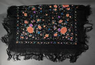 A Chinese silk fringed piano shawl, the black ground richly decorated with flowers and foliage,