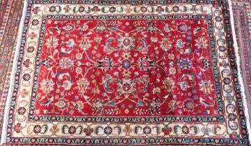 A contemporary North West Persian Tabriz rug, the red ground with flowering vine design, 205 cm x