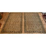 A pair of decorative antique Persian rugs, the repeat design of boteh on brown-red ground within