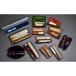 A selection of twelve cased cheroot/cigarette-holders, variously in amber, meerschaum, silver,