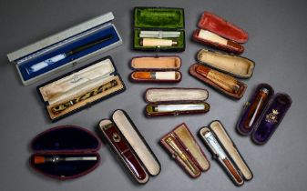 A selection of twelve cased cheroot/cigarette-holders, variously in amber, meerschaum, silver,