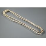 A pearl necklace comprising two rows of graduated cultured pearls on oval pearl and diamond set snap