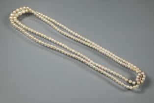 A pearl necklace comprising two rows of graduated cultured pearls on oval pearl and diamond set snap