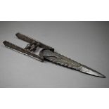 An antique Indian steel katar punch-dagger, the 24 cm blade with double scalloped edge, the floral-