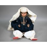 An Ernst Heubach 1902/6/0 bisque-headed costume dolls with stuffed fabric body with ceramic fore-