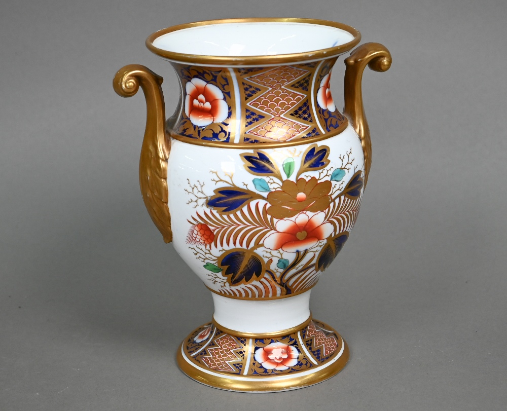 An early 19th century Spode china vase with twin scroll handles, decorated in the Imari palette with