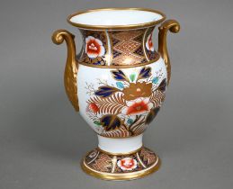 An early 19th century Spode china vase with twin scroll handles, decorated in the Imari palette with